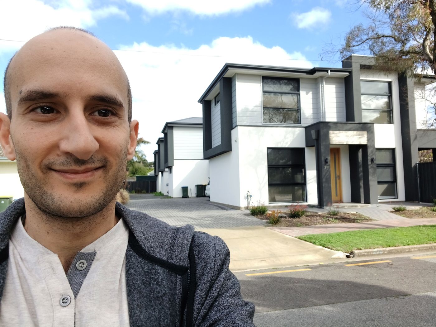 Peter Aquilina, Adelaide property developer, in front of a completed House-Proud development